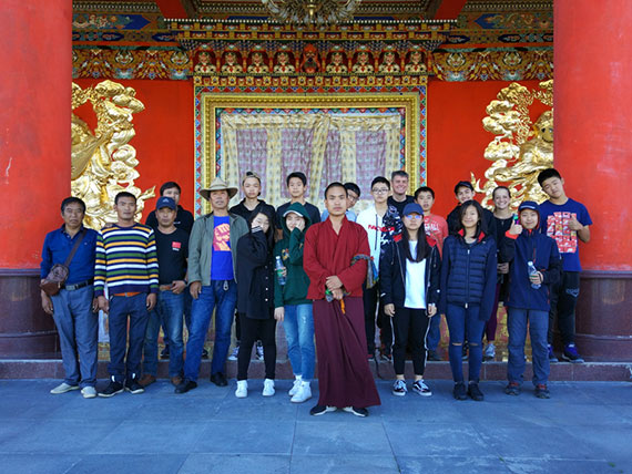students with a monk in Tibet